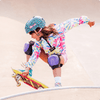 girl dressed in tie dye Justice hoodie and a cheetah print helmet skateboarding